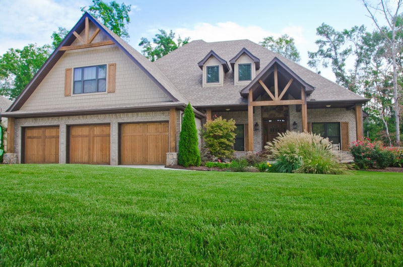 Lush, healthy, green grass in the front yard of a home treated by Fairway Lawns